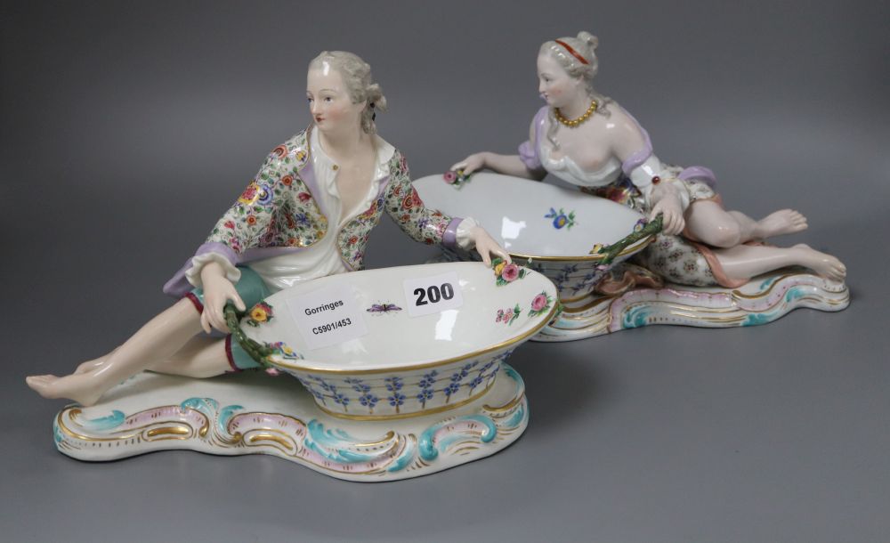 A pair of 19th century Meissen figural baskets, one numbered 2863, the other 2858